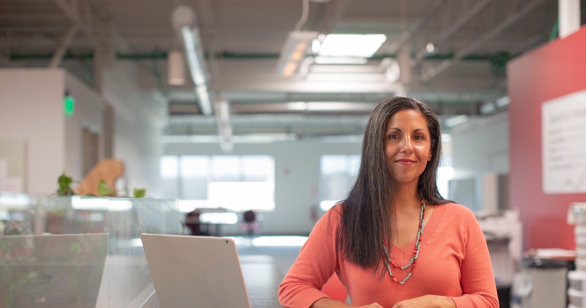 Whitby business owner standing in her own workspace, ready to develop leaders internally from her team
