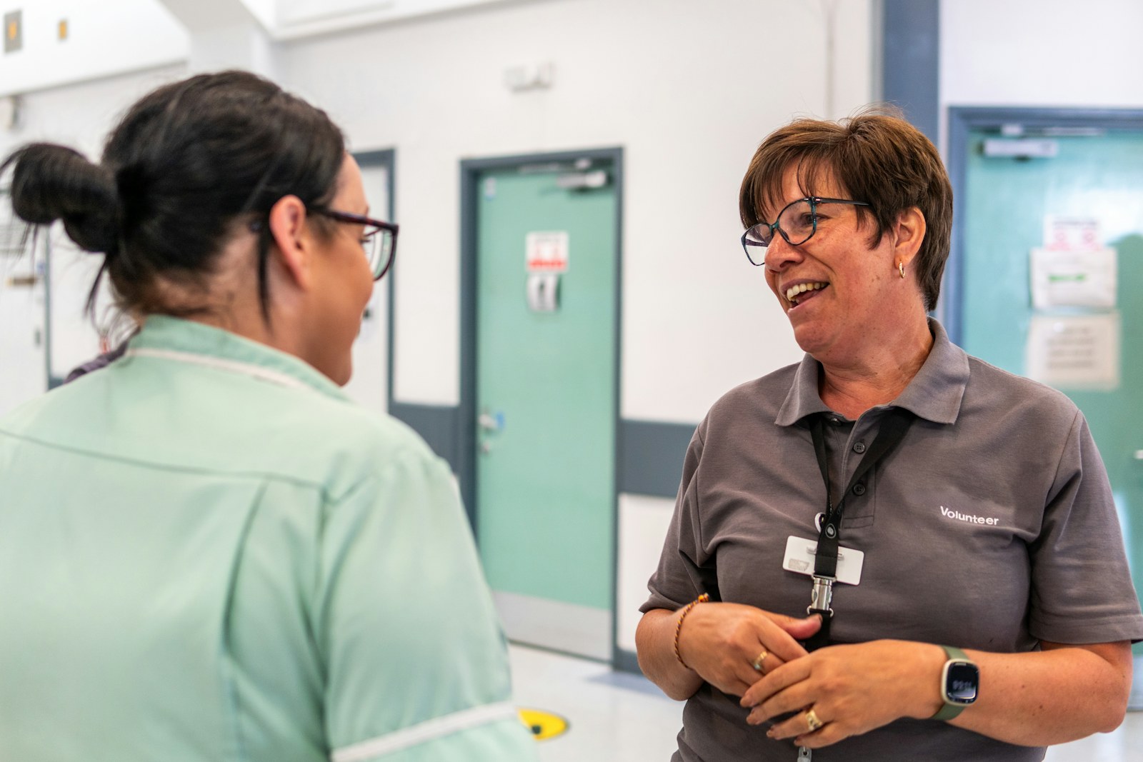 Nurse and colleague talking in a hospital corridor, healthcare leadership development in Durham Region
